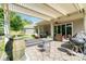 Spacious covered patio area with seating, barbecue, and a tranquil outdoor setting at 3899 Zemosa Nw Ln, Concord, NC 28027