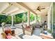 Relaxing back patio with a ceiling fan, outdoor seating, and a well-manicured garden view at 3899 Zemosa Nw Ln, Concord, NC 28027