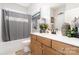 Bathroom featuring a shower-tub combo, white vanity, and storage at 3899 Zemosa Nw Ln, Concord, NC 28027