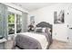 Bedroom features a comfortable bed, natural light and view of outdoor patio at 3899 Zemosa Nw Ln, Concord, NC 28027