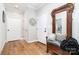 Inviting entryway with hardwood floors, decorative mirror, and seating bench for convenient comfort at 3899 Zemosa Nw Ln, Concord, NC 28027