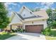 Charming home features a two-car garage and a beautifully landscaped front yard at 3899 Zemosa Nw Ln, Concord, NC 28027