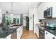 Spacious kitchen with stainless steel appliances and island; view opens to the living room and outdoor patio at 3899 Zemosa Nw Ln, Concord, NC 28027