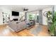 Open living room with fireplace, TV, hardwood floors, and sliding glass doors to the outdoor space at 3899 Zemosa Nw Ln, Concord, NC 28027