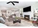 Cozy living room featuring a fireplace, TV, and comfortable seating at 3899 Zemosa Nw Ln, Concord, NC 28027