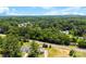Scenic aerial view of a neighborhood surrounded by lush green trees and train tracks, offering peaceful surroundings at 400 N Main Gq St, Granite Quarry, NC 28146