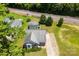 Aerial view of a home featuring a long driveway and proximity to railroad tracks and lush greenery at 400 N Main Gq St, Granite Quarry, NC 28146