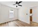 Hardwood bedroom featuring a ceiling fan, a window, and bright light at 400 N Main Gq St, Granite Quarry, NC 28146