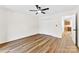 Bright bedroom featuring hardwood floors, a ceiling fan, and a closet at 400 N Main Gq St, Granite Quarry, NC 28146