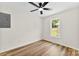 Bright bedroom featuring hardwood floors, a window view, and a modern ceiling fan at 400 N Main Gq St, Granite Quarry, NC 28146