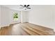 Hardwood bedroom featuring a ceiling fan, a window, and bright light at 400 N Main Gq St, Granite Quarry, NC 28146