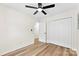 Cozy bedroom featuring hardwood floors, a ceiling fan, and a closet at 400 N Main Gq St, Granite Quarry, NC 28146