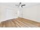 Bright bedroom featuring hardwood floors, a ceiling fan, and a closet at 400 N Main Gq St, Granite Quarry, NC 28146