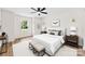 Spacious bedroom featuring hardwood floors, two benches, and neutral decor at 400 N Main Gq St, Granite Quarry, NC 28146
