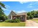 Quaint brick home with a well-maintained lawn, complemented by mature trees and a basketball hoop at 400 N Main Gq St, Granite Quarry, NC 28146