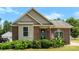 Charming brick home with a well-manicured lawn, complemented by lush landscaping around the front entrance at 400 N Main Gq St, Granite Quarry, NC 28146