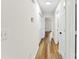 Well-lit hallway featuring hardwood floors, white doors and a neutral color palette at 400 N Main Gq St, Granite Quarry, NC 28146