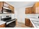 Bright kitchen with wooden cabinets, stainless steel appliances, and light countertops at 400 N Main Gq St, Granite Quarry, NC 28146