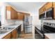 Updated kitchen featuring stainless steel appliances, wooden cabinets, and modern countertops at 400 N Main Gq St, Granite Quarry, NC 28146