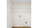 Well-lit laundry room with white walls, wood-look flooring, and practical shelving for organization and storage at 400 N Main Gq St, Granite Quarry, NC 28146