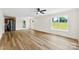 Spacious open concept living area featuring modern flooring, abundant natural light, and a stainless steel refrigerator at 400 N Main Gq St, Granite Quarry, NC 28146