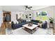 Bright, modern living room featuring a large sectional sofa and windows overlooking a green backyard at 400 N Main Gq St, Granite Quarry, NC 28146