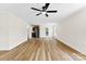 Open concept living area featuring modern flooring, lots of natural light, and a stainless steel refrigerator at 400 N Main Gq St, Granite Quarry, NC 28146