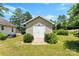Charming outbuilding with double doors, a wooden walkway, and greenery, situated in a well-maintained yard at 400 N Main Gq St, Granite Quarry, NC 28146