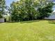 A spacious backyard featuring a well-maintained lawn and a storage shed at 405 Jones Street St, Monroe, NC 28110