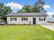 Charming single-story home with a well-manicured lawn, fresh landscaping, and a new roof at 405 Jones Street St, Monroe, NC 28110