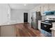 Modern kitchen featuring stainless steel appliances, tiled backsplash, and granite countertops at 405 Jones Street St, Monroe, NC 28110