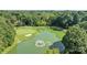 An aerial shot showcasing a pond, golf course and wooded views of the area at 4208 Burning Tree Dr, Charlotte, NC 28277