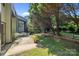 This backyard features a small patio area, grassy space, and natural landscaping at 4208 Burning Tree Dr, Charlotte, NC 28277