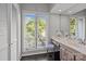This bathroom features a nice vanity, a vanity mirror, and a large window overlooking the property at 4208 Burning Tree Dr, Charlotte, NC 28277