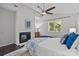 The bedroom features a modern ceiling fan, a cozy fireplace, and large windows at 4208 Burning Tree Dr, Charlotte, NC 28277