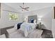 The bedroom boasts a modern ceiling fan, a decorative headboard, and large windows at 4208 Burning Tree Dr, Charlotte, NC 28277