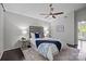 The bedroom boasts a modern ceiling fan, a decorative headboard, and large windows at 4208 Burning Tree Dr, Charlotte, NC 28277