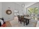 Bright dining room features a wooden table, modern light fixture, and open view to the kitchen at 4208 Burning Tree Dr, Charlotte, NC 28277