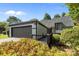 Exterior elevation of home featuring a two-car garage and lush landscaping at 4208 Burning Tree Dr, Charlotte, NC 28277