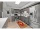 Kitchen features stainless steel appliances, gray cabinets, and a skylight for natural light at 4208 Burning Tree Dr, Charlotte, NC 28277