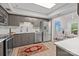 Spacious kitchen featuring stainless steel appliances, gray cabinets, and an adjacent sitting room at 4208 Burning Tree Dr, Charlotte, NC 28277