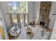 Bright living room featuring a stone fireplace and large windows offering a serene view at 4208 Burning Tree Dr, Charlotte, NC 28277