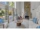 Inviting living room boasts a stone fireplace, natural light, and access to the patio at 4208 Burning Tree Dr, Charlotte, NC 28277