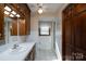 Bathroom with white tile, oak cabinets, and a shower at 47209 Paradise Ln, Norwood, NC 28128