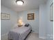 Small bedroom features a twin bed with a colorful striped comforter at 47209 Paradise Ln, Norwood, NC 28128