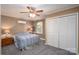 Cozy bedroom with ceiling fan, closet and blue striped bedspread at 47209 Paradise Ln, Norwood, NC 28128