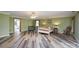 Spacious bedroom with green walls, wood flooring, and ample natural light, creating a cozy retreat at 47209 Paradise Ln, Norwood, NC 28128