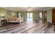 Spacious bedroom with modern flooring and access to sunroom providing lake views at 47209 Paradise Ln, Norwood, NC 28128