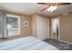 Comfortable bedroom featuring a ceiling fan, closet, and serene natural light at 47209 Paradise Ln, Norwood, NC 28128