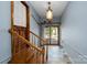 Bright entryway with wood trimmed doorway to outside and decorative light fixture at 47209 Paradise Ln, Norwood, NC 28128